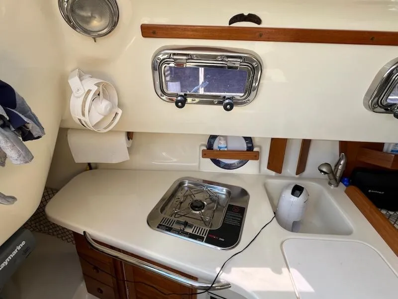 Slide: The Image of Compact galley in a 2010 Seaward 26RK sailboat with stove, sink, and storage. - 17