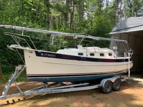 Slide: The Image of 2010 Seaward 26RK sailboat on a trailer in a wooded area. - 2