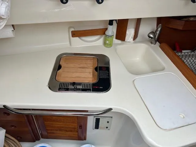 Slide: The Image of Compact kitchen area in a 2010 Seaward 26RK sailboat with stove and sink. - 28