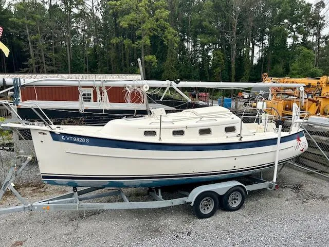 Slide: The Image of 2010 Seaward 26RK sailboat on trailer, parked outdoors near trees and equipment. - 30