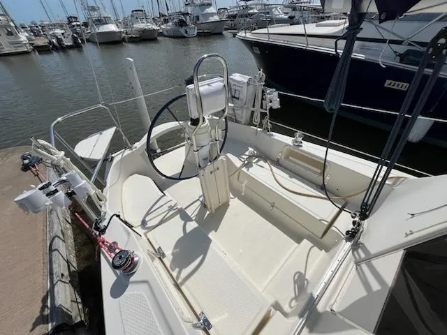 Slide: The Image of 2010 Seaward 26RK sailboat cockpit at marina, featuring steering wheel and rigging. - 6