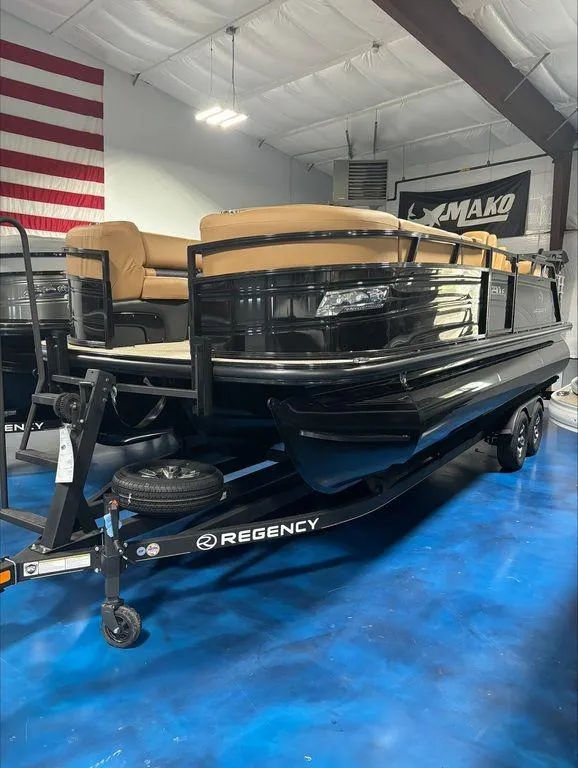 Slide: The Image of 2024 Regency 230 LE3 Sport pontoon boat in showroom. - 1