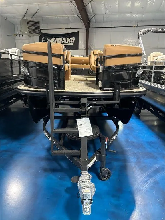 Slide: The Image of 2024 Regency 230 LE3 Sport pontoon boat on display in a showroom. - 4