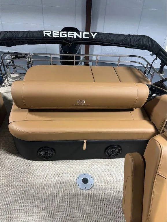 Slide: The Image of 2024 Regency 230 LE3 Sport boat with tan leather seating and black accents. - 6