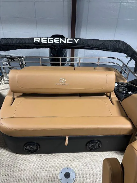 Slide: The Image of 2024 Regency 230 LE3 Sport boat with tan leather seating and branded backrest. - 7