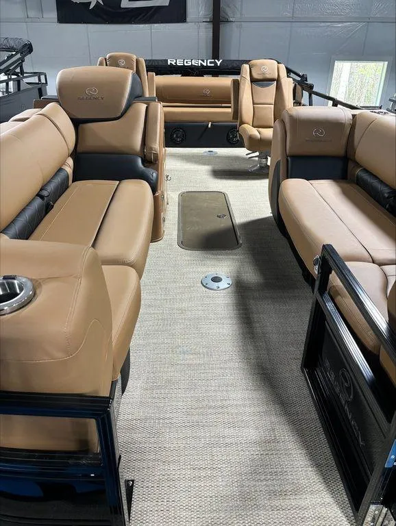 Slide: The Image of 2024 Regency 230 LE3 Sport pontoon boat with luxurious tan seating. - 9