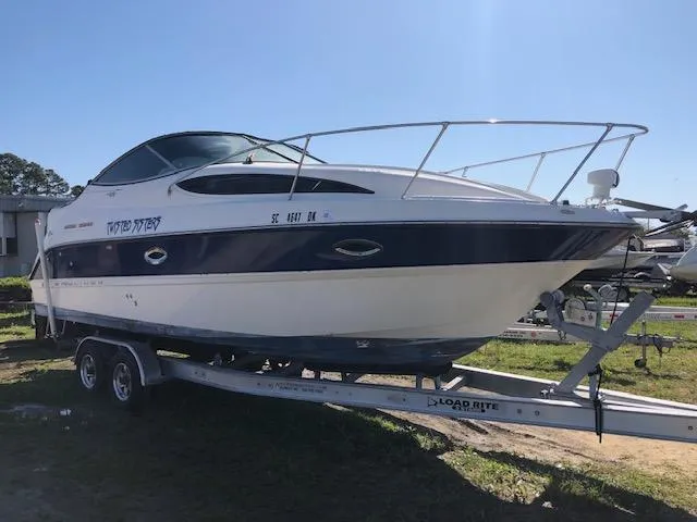 Slide: The Image of 2007 Bayliner 275 boat on a Load Rite trailer in a sunny outdoor setting. - 1