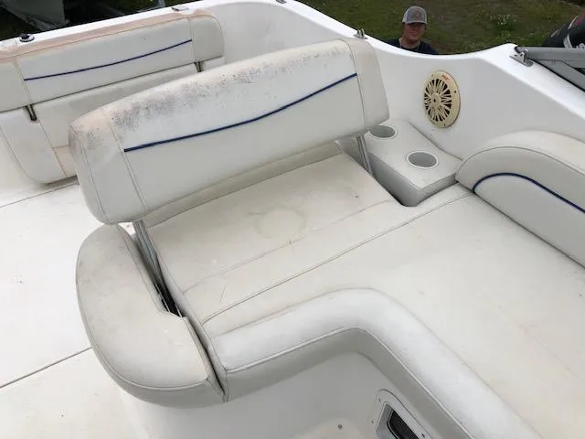 Slide: The Image of 2007 Bayliner 275 boat interior with white seating and cup holders. - 12