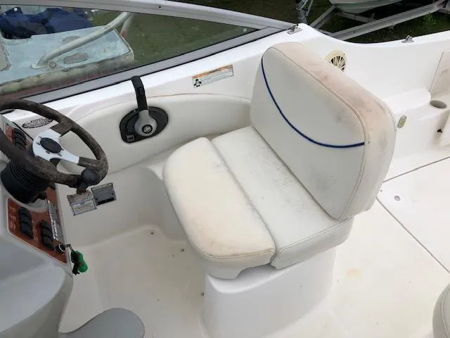 Slide: The Image of 2007 Bayliner 275 boat cockpit with steering wheel and captain's seat. - 13
