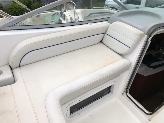 Slide: The Image of 2007 Bayliner 275 boat interior with white seating and blue trim. - 17