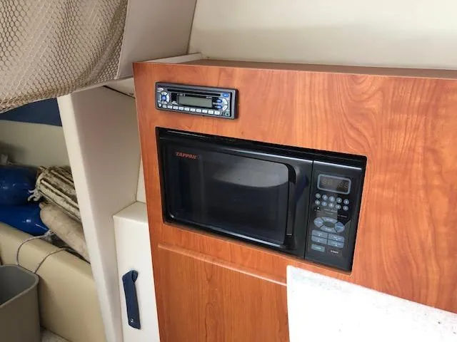 Slide: The Image of Built-in microwave and stereo system in the 2007 Bayliner 275 boat cabin. - 23