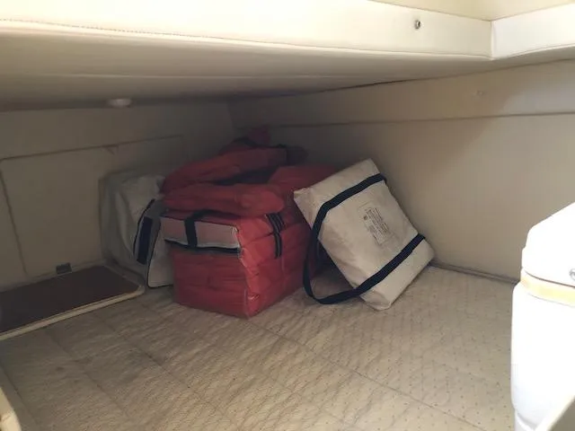 Slide: The Image of Storage compartment in 2007 Bayliner 275 boat with life jackets and bags. - 25