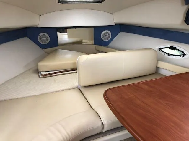 Slide: The Image of Interior cabin of a 2007 Bayliner 275 boat with seating and table. - 26