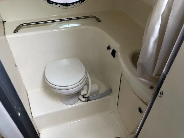 Slide: The Image of 2007 Bayliner 275 boat bathroom with toilet and sink. - 27