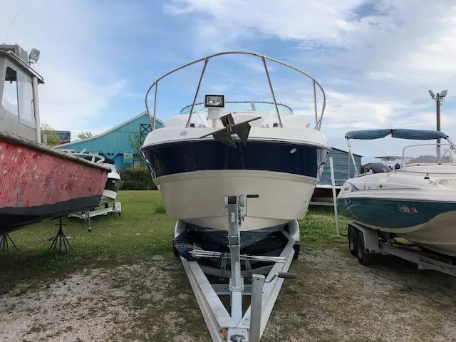 Slide: The Image of 2007 Bayliner 275 boat on a trailer, front view, parked outdoors. - 7