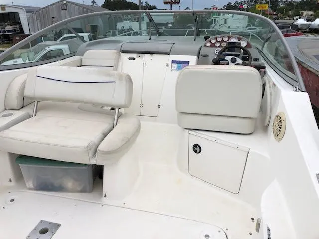 Slide: The Image of 2007 Bayliner 275 boat interior with white seating and control panel. - 8