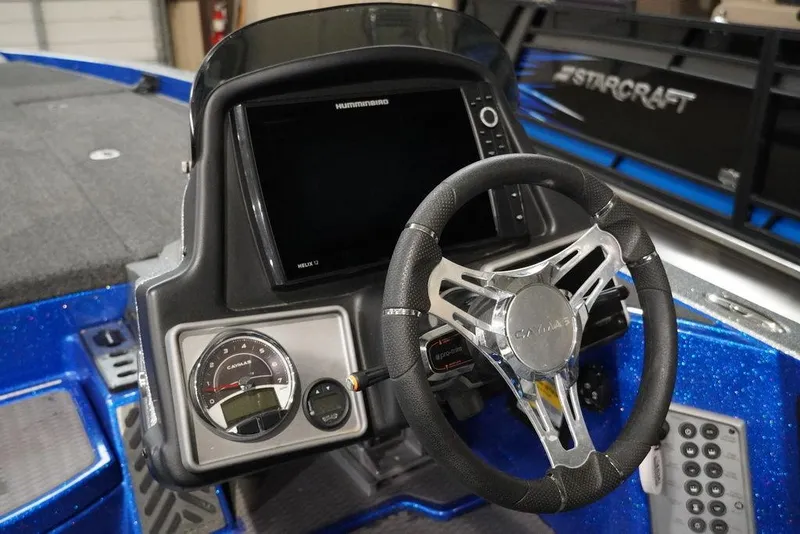 Slide: The Image of 2020 Caymas CX 20 PRO boat dashboard with steering wheel and electronic display. - 4