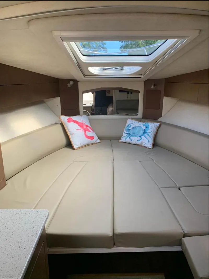 Slide: The Image of Interior of 2013 Sea Ray Sundancer with skylight and decorative pillows. - 10