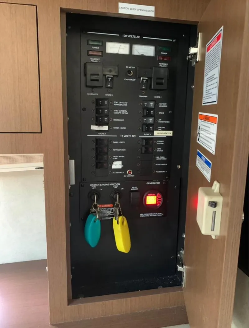 Slide: The Image of Electrical control panel inside 2013 Sea Ray Sundancer boat, featuring switches and labeled keys. - 4