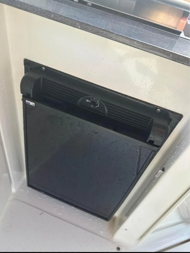 Slide: The Image of Black refrigerator on 2013 Sea Ray Sundancer boat, with water droplets on the surface. - 6