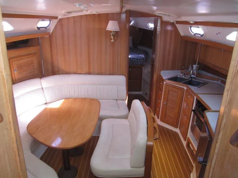Slide: The Image of 2007 Catalina MkII sailboat interior with dining area, kitchen, and sleeping quarters. - 1