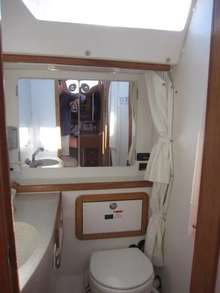 Slide: The Image of Bathroom interior of a 2007 Catalina MkII sailboat with sink, mirror, and toilet. - 14
