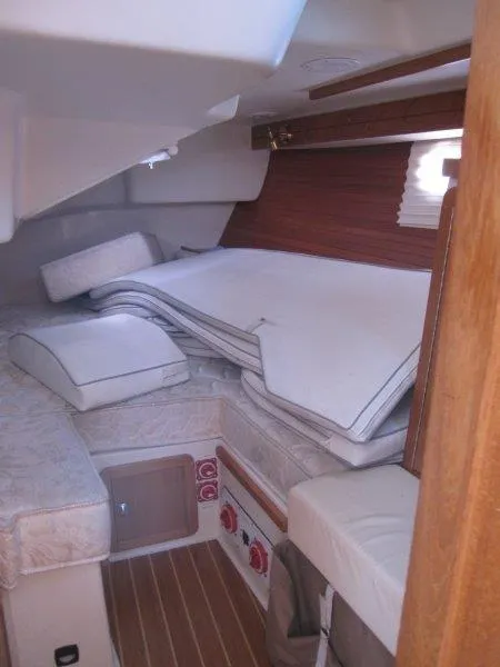 Slide: The Image of Interior cabin of a 2007 Catalina MkII sailboat with cushions and wooden accents. - 16