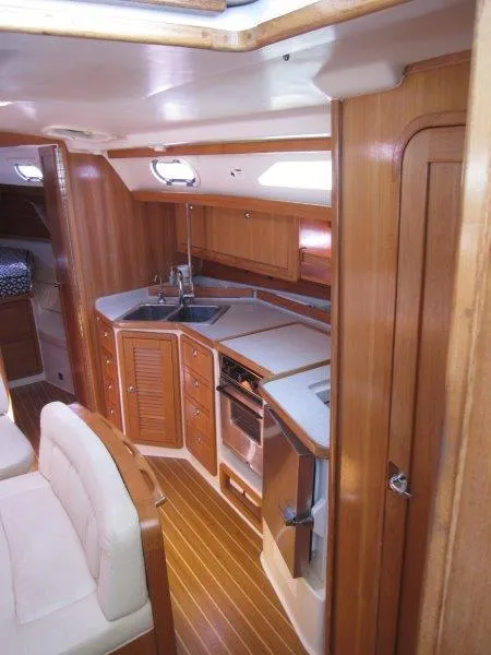 Slide: The Image of 2007 Catalina MkII yacht interior with modern kitchen and wooden cabinetry. - 2