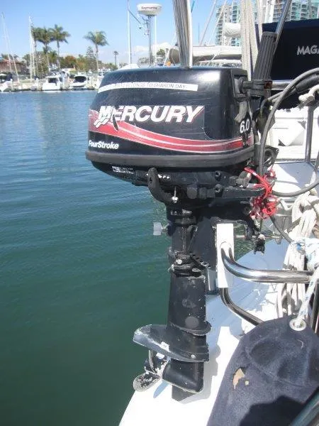 Slide: The Image of Mercury 60 outboard motor on a 2007 Catalina MkII sailboat in a marina. - 25