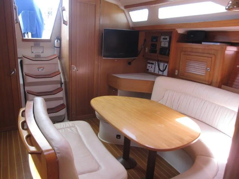 Slide: The Image of Interior of 2007 Catalina MkII sailboat with dining area, TV, and navigation equipment. - 3