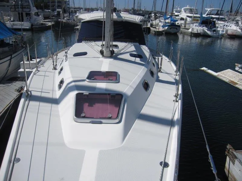 Slide: The Image of 2007 Catalina MkII sailboat docked in a marina, view of the deck and hatches. - 32