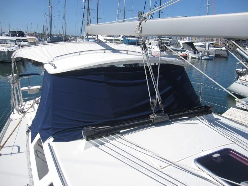 Slide: The Image of 2007 Catalina MkII sailboat docked at marina with blue canvas cover. - 34