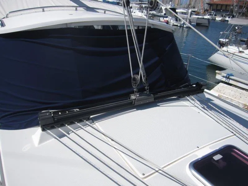 Slide: The Image of 2007 Catalina MkII sailboat deck with rigging and blue cover. - 36