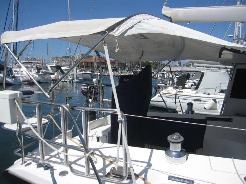 Slide: The Image of 2007 Catalina MkII sailboat docked in a marina with a sunshade canopy. - 41