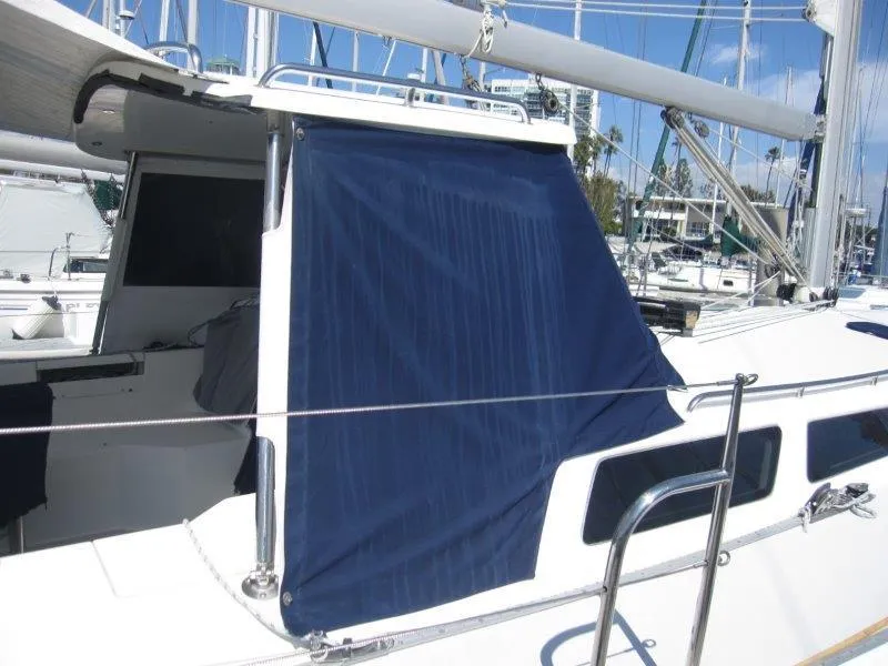 Slide: The Image of 2007 Catalina MkII sailboat with blue canvas cover in marina. - 42