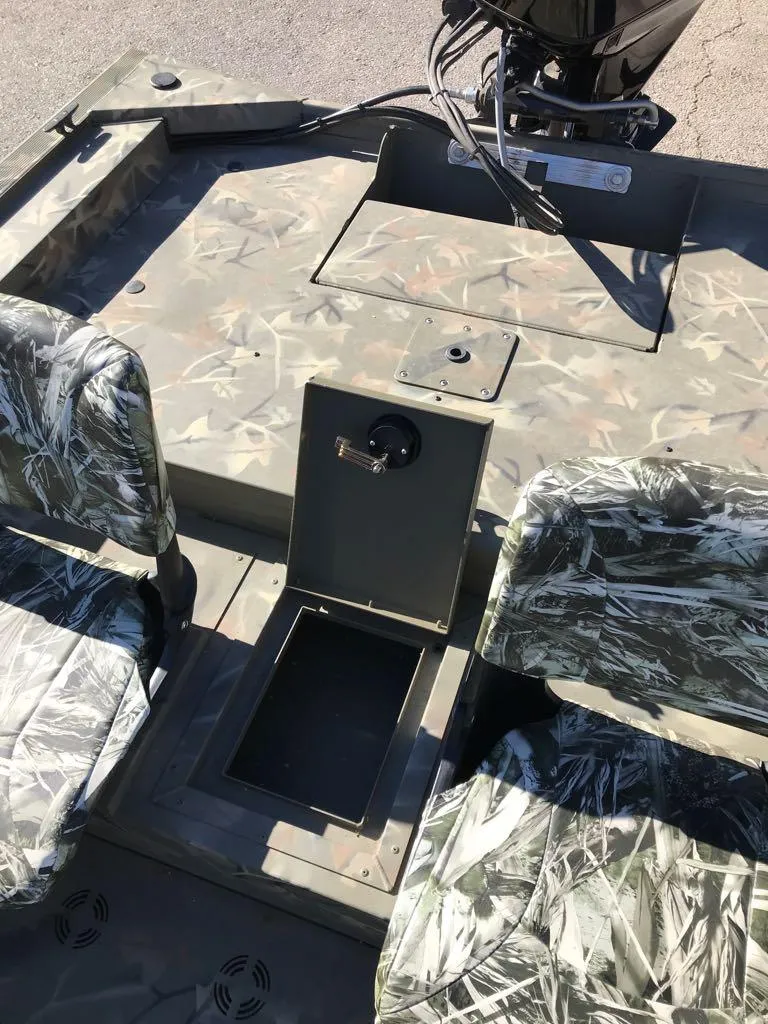 Slide: The Image of 2024 Tracker Grizzly 1754 SC boat interior with camo seats and storage compartment. - 12