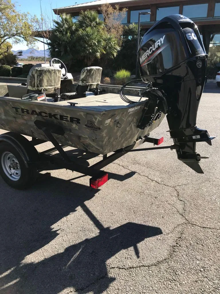 Slide: The Image of 2024 Tracker Grizzly 1754 SC boat with Mercury engine on trailer. - 13