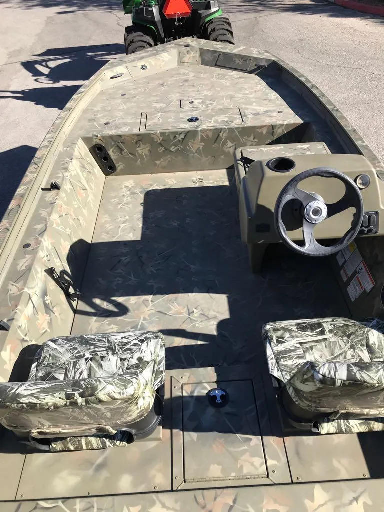 Slide: The Image of 2024 Tracker Grizzly 1754 SC boat with camouflage interior and steering console. - 15