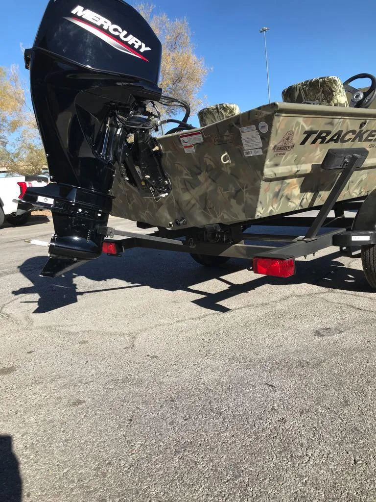 Slide: The Image of 2024 Tracker Grizzly 1754 SC boat with Mercury outboard motor in parking lot. - 5