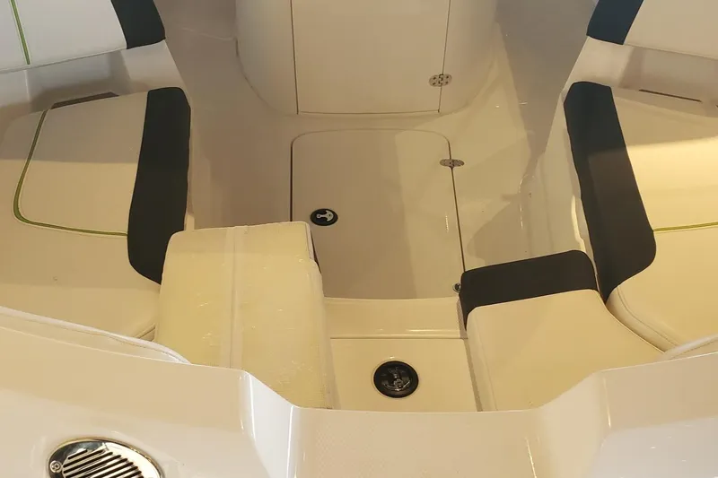 Slide: The Image of 2024 Tahoe 2150 CC boat interior with cushioned seating and storage compartments. - 7