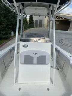 Slide: The Image of 2023 Mako 214 CC center console boat with T-top and spacious deck. - 15