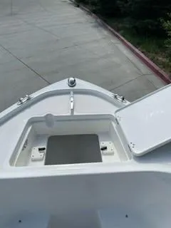 Slide: The Image of 2023 Mako 214 CC boat bow storage compartment. - 16