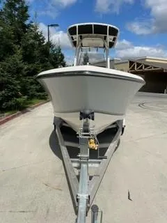 Slide: The Image of 2023 Mako 214 CC boat on trailer, front view, outdoors. - 3