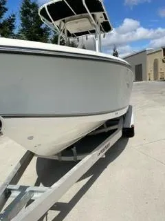 Slide: The Image of 2023 Mako 214 CC boat on a trailer in a driveway. - 5