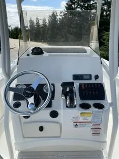 Slide: The Image of 2023 Mako 214 CC boat console with steering wheel and control panel. - 8