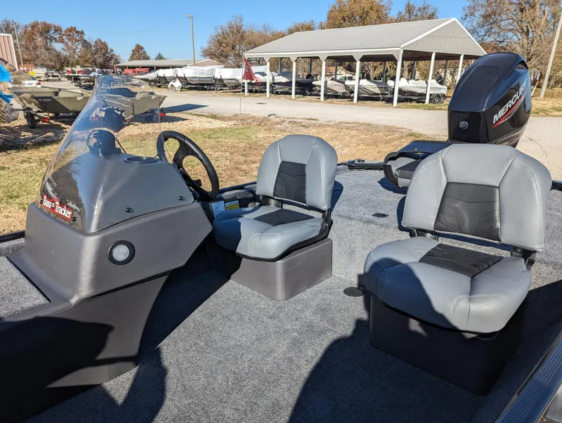 Slide: The Image of 2024 Tracker Bass Tracker Classic XL boat interior with two seats and steering console. - 13
