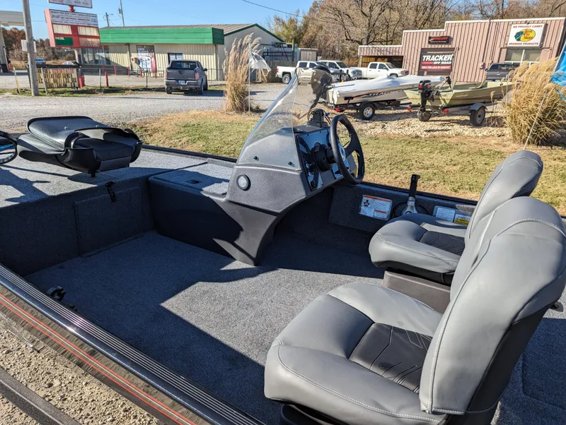 Slide: The Image of 2024 Tracker Bass Tracker Classic XL boat interior with seats and steering console. - 14