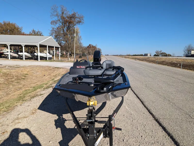 Slide: The Image of 2024 Tracker Bass Tracker Classic XL boat on a trailer, parked on a rural road. - 16