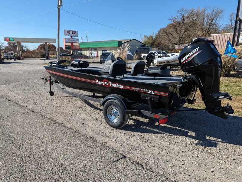 Slide: The Image of 2024 Tracker Bass Tracker Classic XL boat with Mercury outboard motor on a trailer. - 3