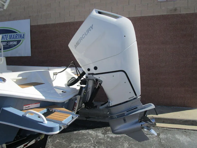 Slide: The Image of 2024 Ranger 2660 Bay boat with Mercury outboard motor, docked at a marina. - 4